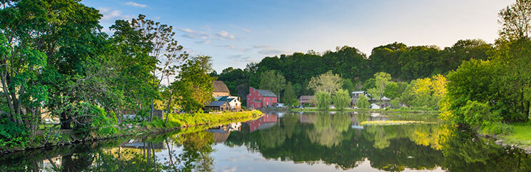 Panoramic view of red mill and pond in Clinton, New Jersey